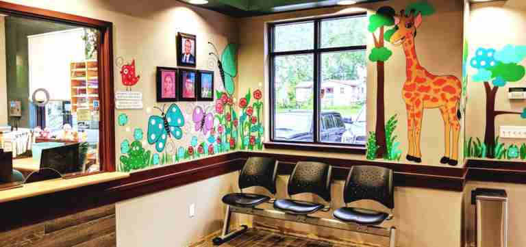 Kids Health Alliance waiting room with colorful wall murals