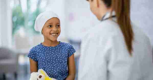 Clinician speaking with a child during a pediatric visit